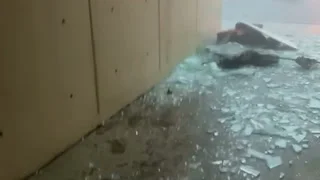 Officer inches from being crushed by falling glass during storm