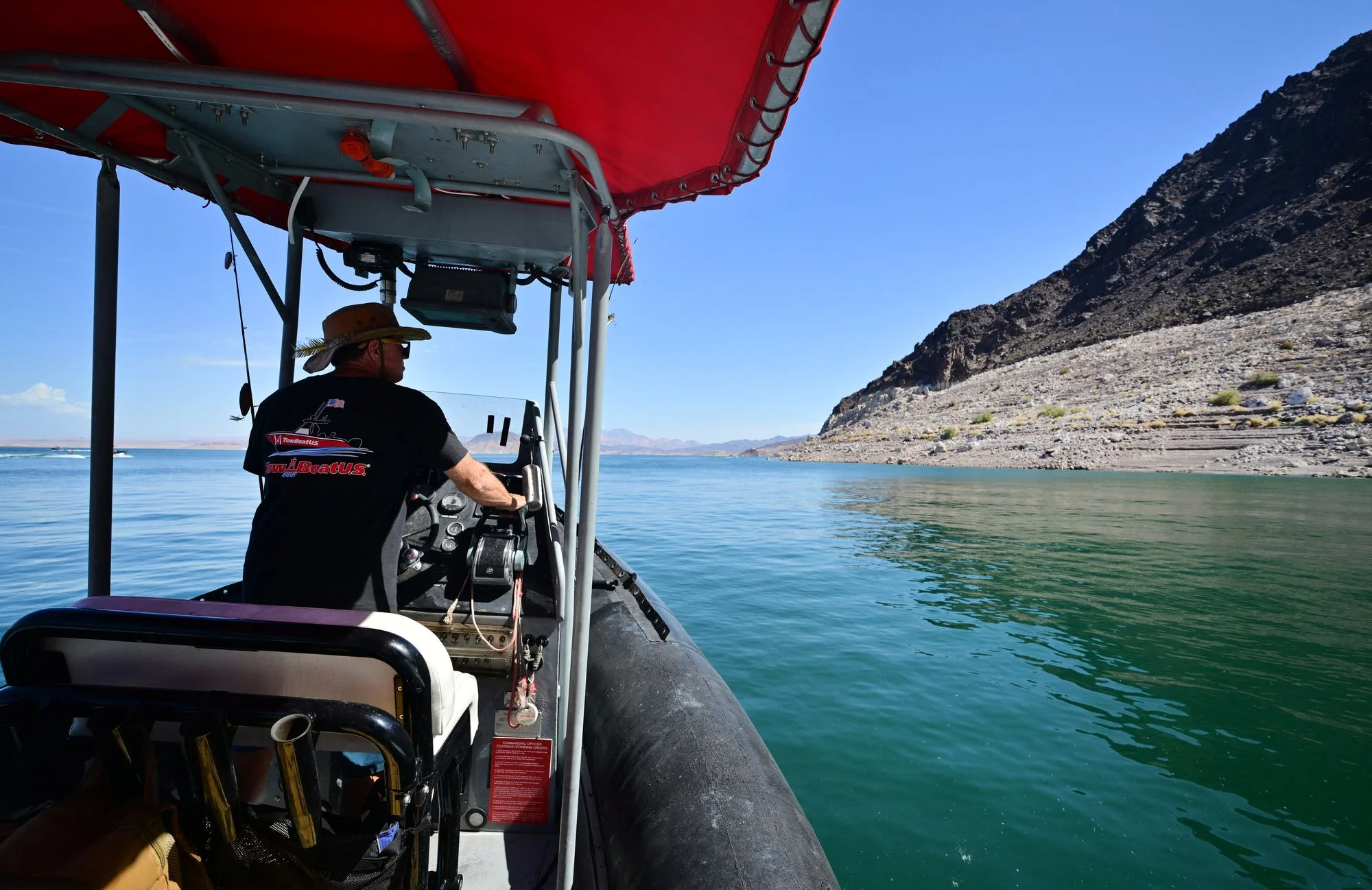 Boat operator Brian Essex navigates his boat on Lake Mead, an offshoot of the Colorado River, in August. Extreme heat worsened by climate change is shrinking water levels. A new map reveals at how America’s rivers are responding to the climate crisis