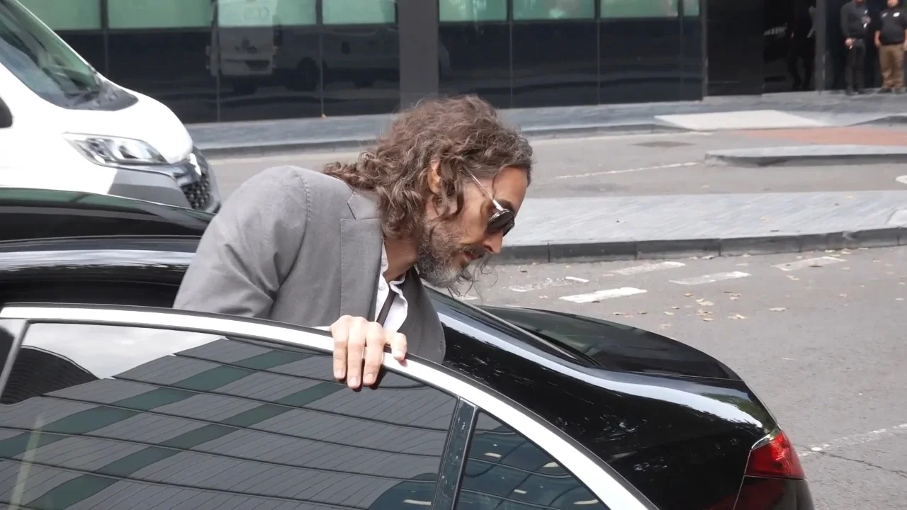 Russell Brand arrives at court for hearing ahead of rape trial