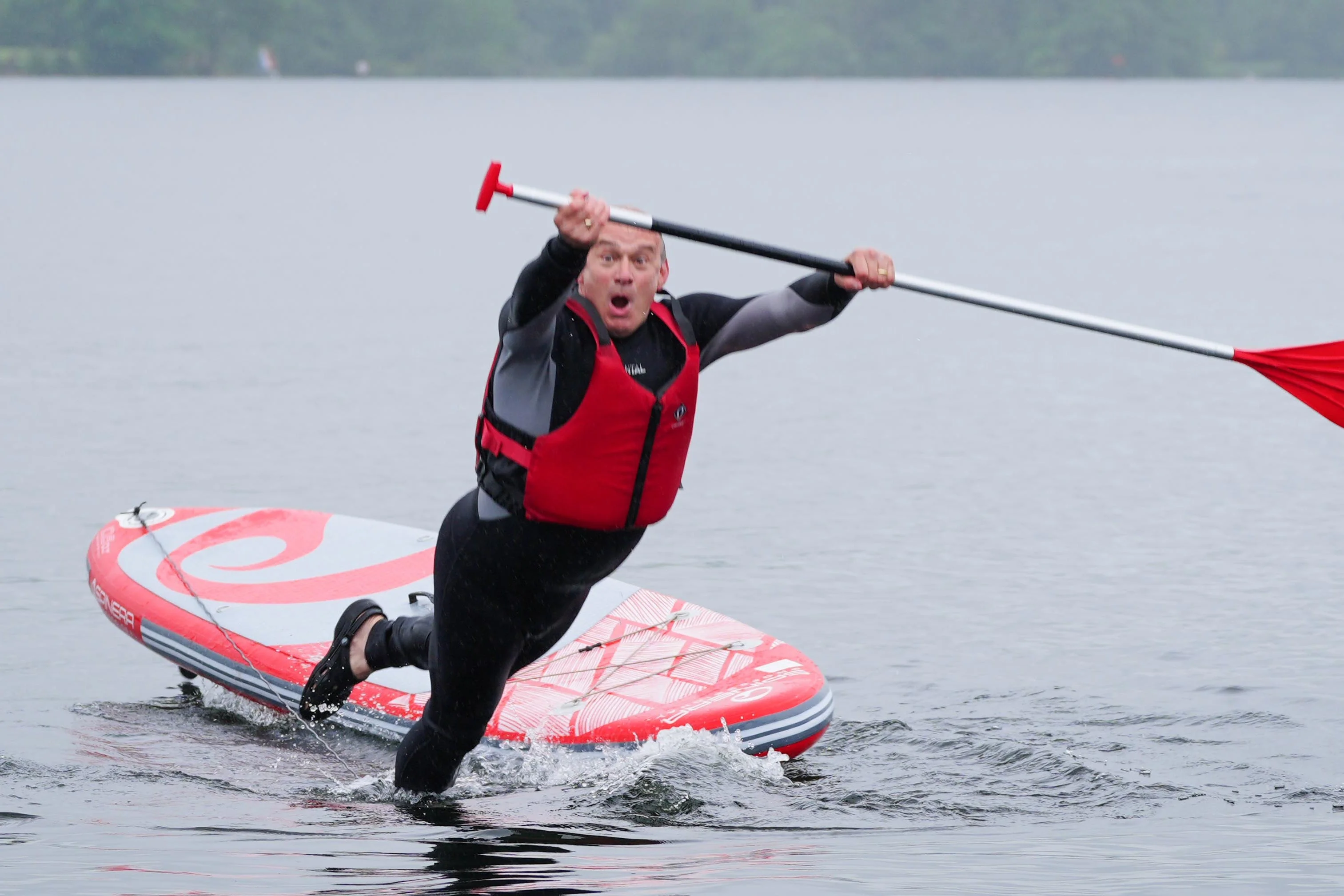Liberal Democrat leader Sir Ed Davey falls into Lake Windermere (Peter Byrne/PA)