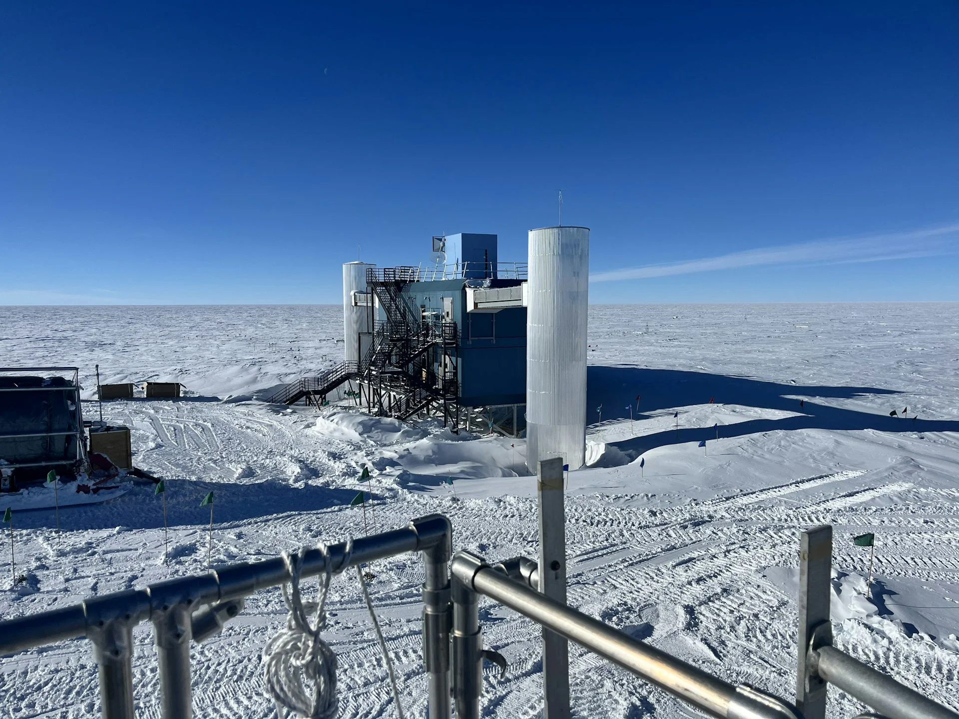 A built structure against blue sky and snowy ground as far as visible.